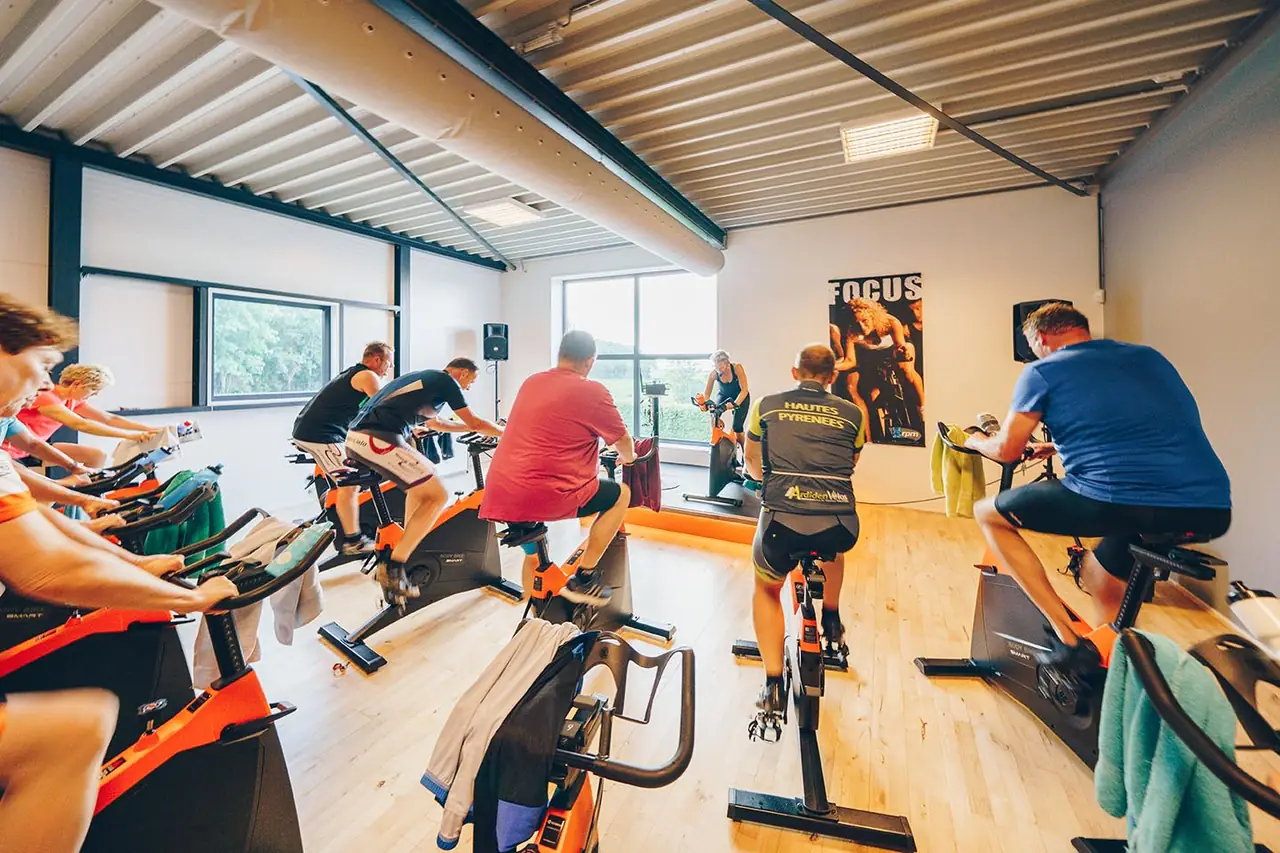 Spinningles bij Shape, deelnemers fietsen op de oranje fietsen